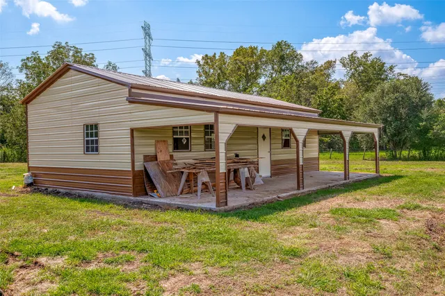 a view of a house with backyard porch and sitting area