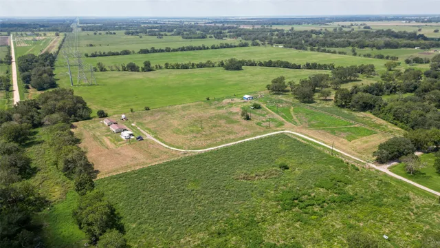 a view of a house with a big yard and potted plants