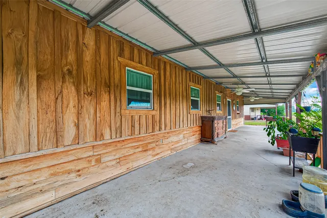 a view of a porch with furniture and a garage