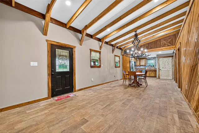 en empty room with furniture and a chandelier