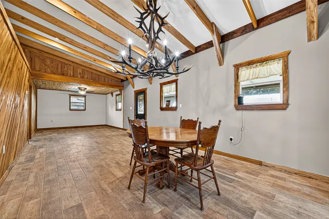 a view of a dining room with furniture and window