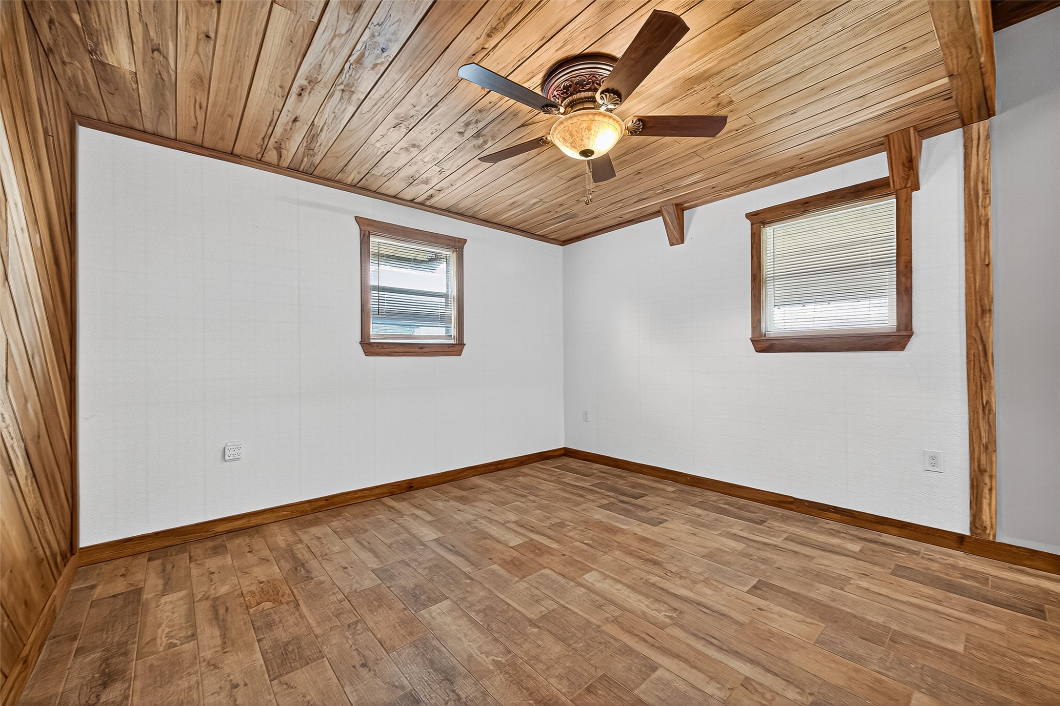 2080 Ave J Street Boling, TX 77420 - Photo 10 of 50 an empty room with wooden floor and windows