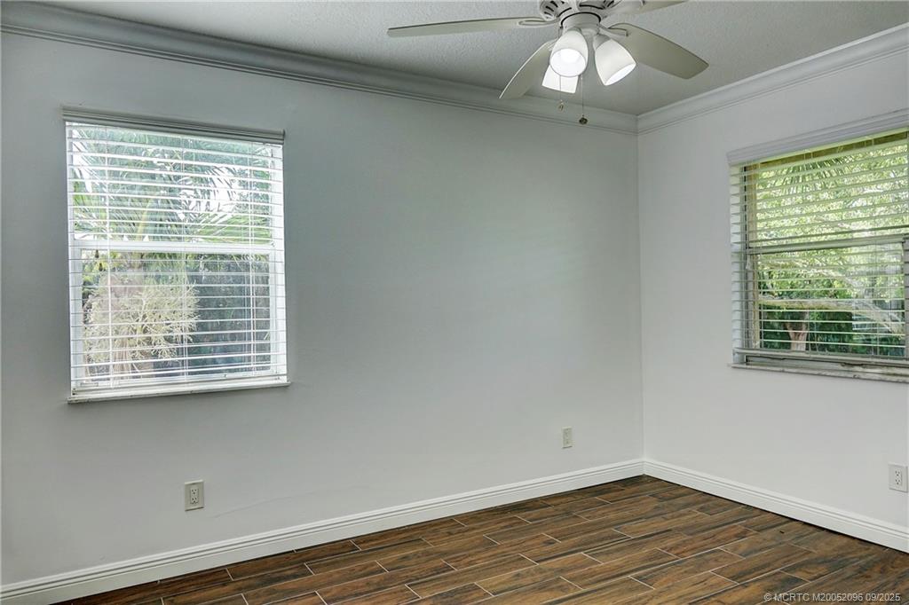 3101 Southeast Aster Lane, Unit 1908 Stuart, FL 34994 - Photo 12 of 24 a view of an empty room with wooden floor and a window