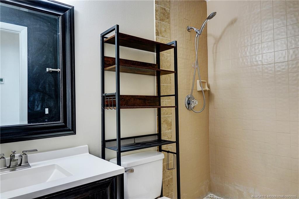 3101 Southeast Aster Lane, Unit 1908 Stuart, FL 34994 - Photo 13 of 24 a bathroom with a sink and mirror
