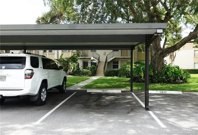 a view of garage with a car parked in it