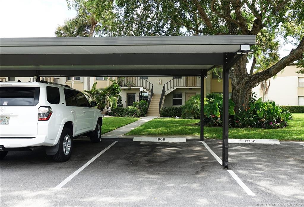 3101 Southeast Aster Lane, Unit 1908 Stuart, FL 34994 - Photo 16 of 24 a view of garage with a car parked in it