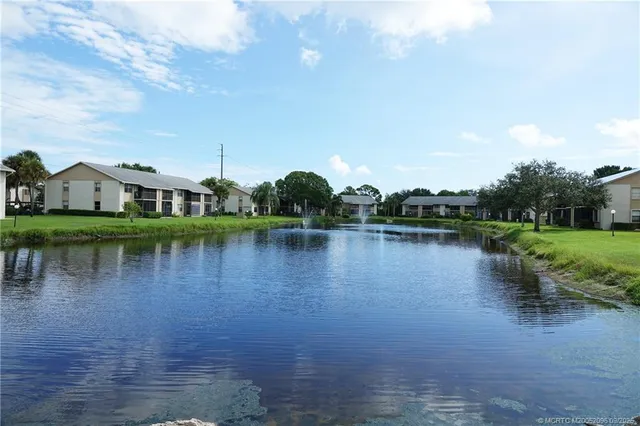 a view of a lake with houses in the background