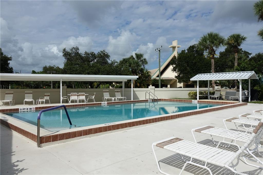 3101 Southeast Aster Lane, Unit 1908 Stuart, FL 34994 - Photo 22 of 24 swimming pool view with a seating space