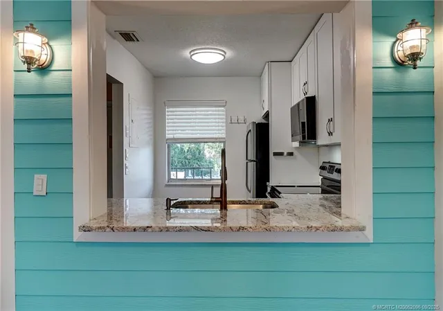 a view of a kitchen with a sink and a window