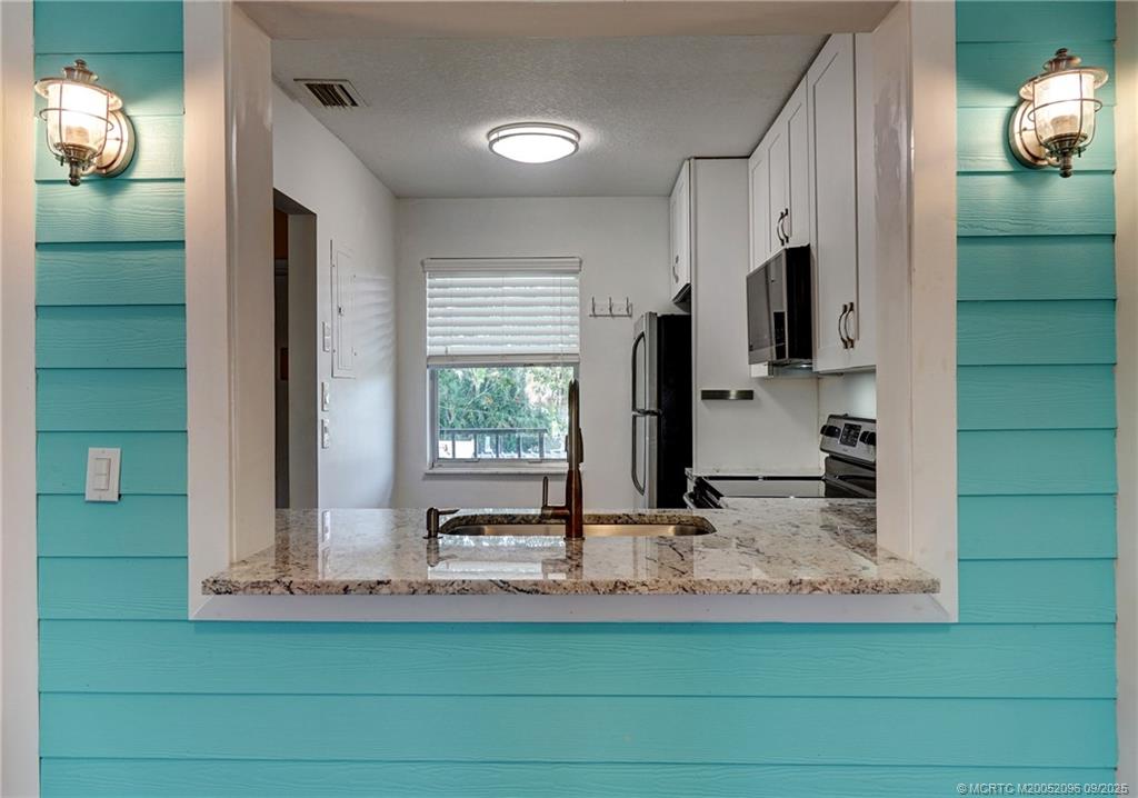 3101 Southeast Aster Lane, Unit 1908 Stuart, FL 34994 - Photo 6 of 24 a view of a kitchen with a sink and a window