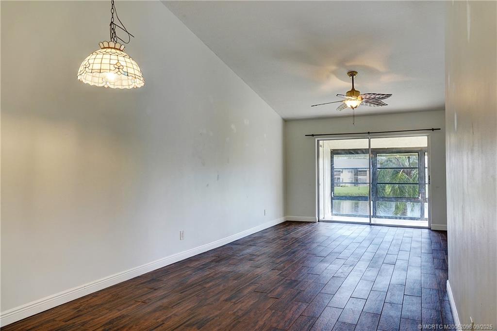 3101 Southeast Aster Lane, Unit 1908 Stuart, FL 34994 - Photo 8 of 24 wooden floor in an empty room with a window
