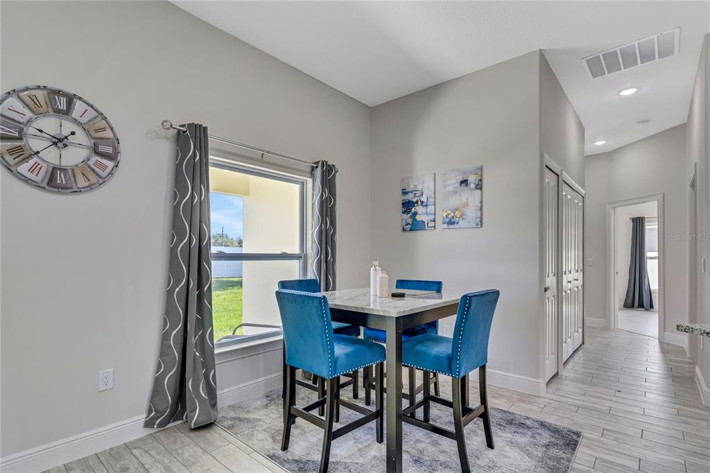 2201 Abalone Boulevard Orlando, FL 32833 - Photo 14 of 32 a view of a dining room with furniture and wooden floor