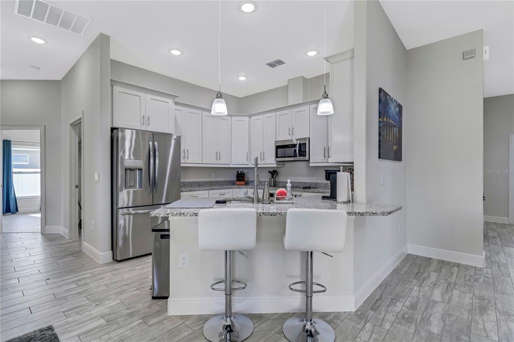 2201 Abalone Boulevard Orlando, FL 32833 - Photo 20 of 32 a kitchen with refrigerator and cabinets