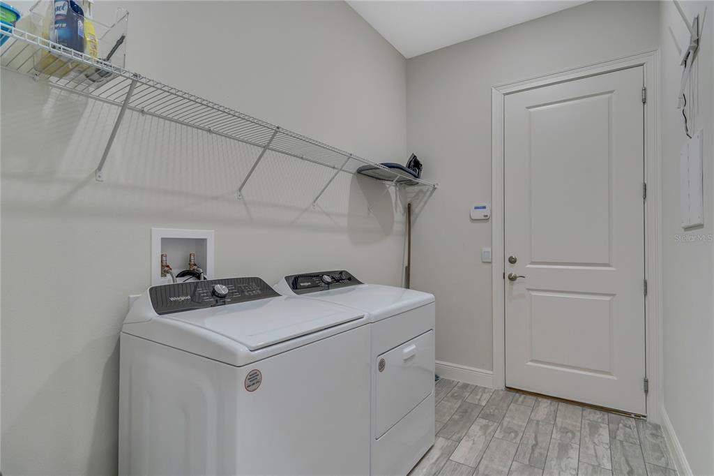 2201 Abalone Boulevard Orlando, FL 32833 - Photo 23 of 32 a utility room with dryer washer and empty racks