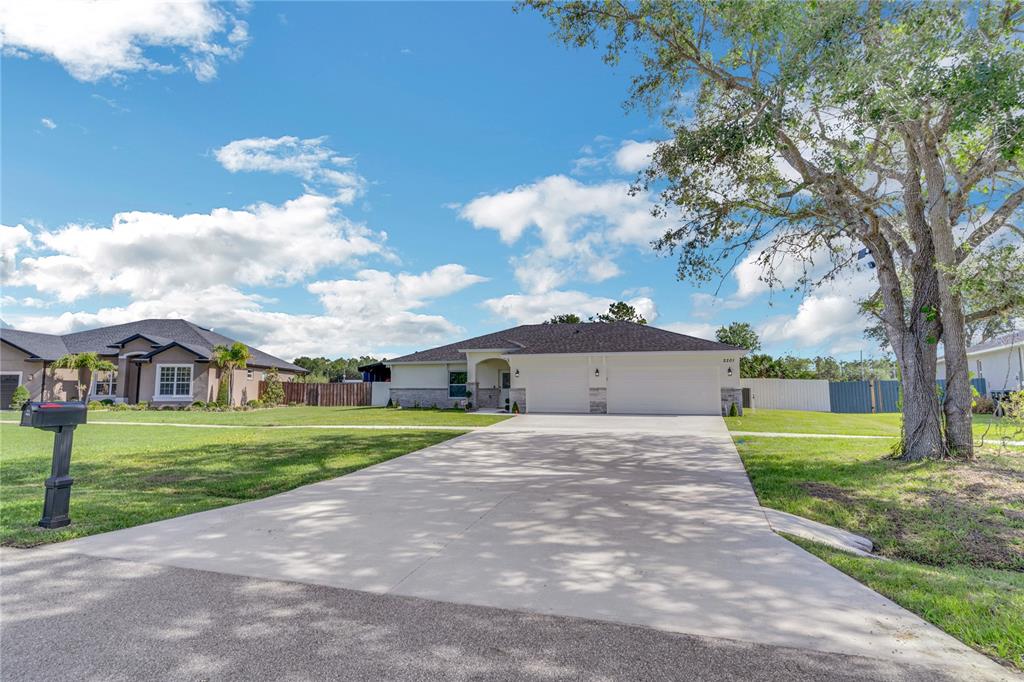 2201 Abalone Boulevard Orlando, FL 32833 - Photo 30 of 32 a front view of a house with a yard and garage