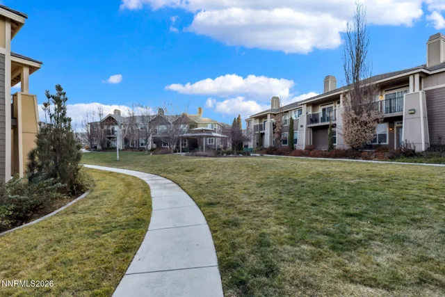 a view of a big house with a big yard and potted plants