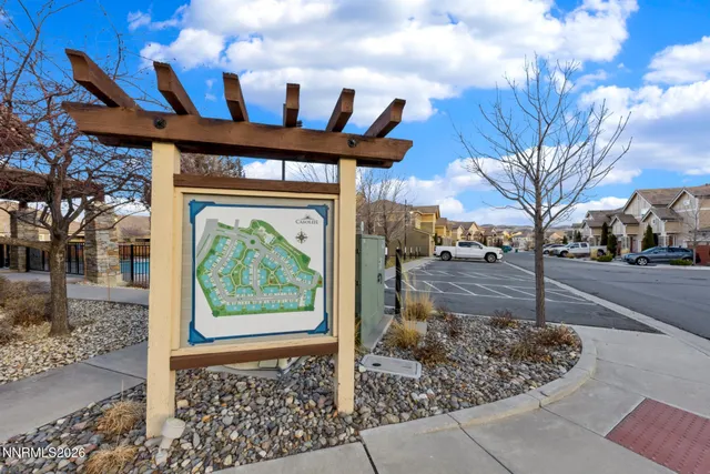 a view of entrance gate of a house with a yard