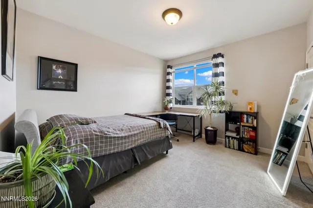 a bedroom with a bed and a desk