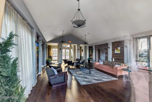 a view of a livingroom with furniture window and wooden floor