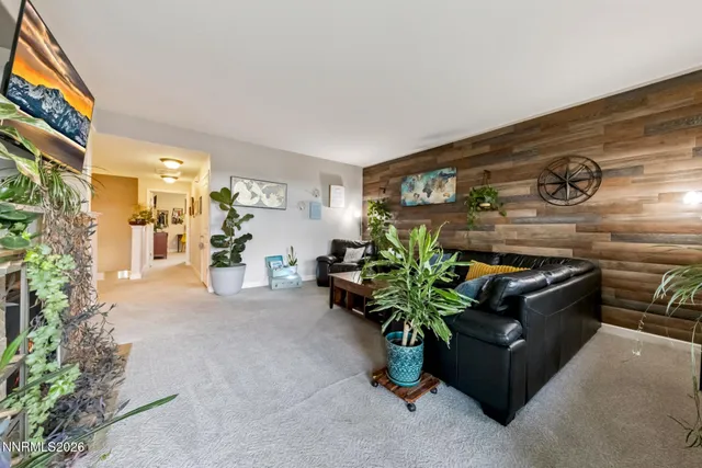 a living room with furniture potted plant and a window