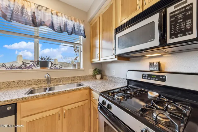 a bathroom with a granite countertop sink a mirror and a shower