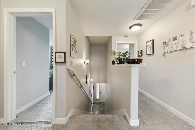 a view of a livingroom with stairs and furniture
