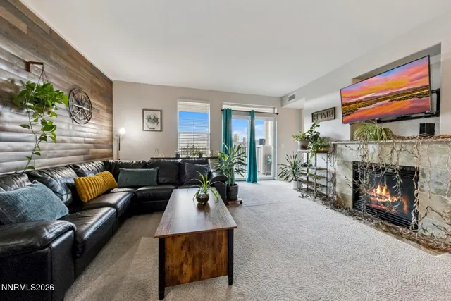 a living room with furniture a fireplace and a flat screen tv