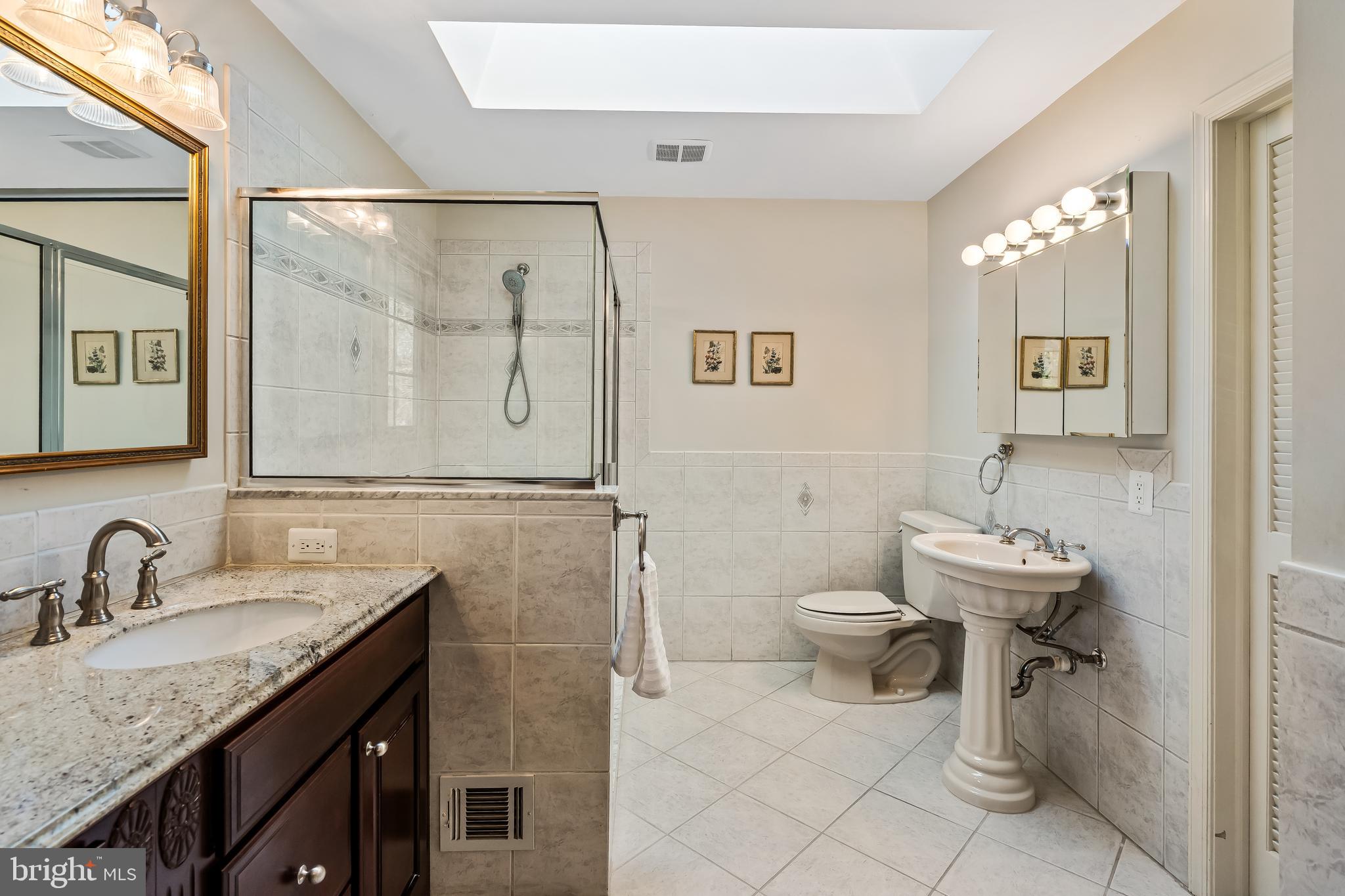 2716 Glencroft Road Vienna, VA 22181 - Photo 32 of 66 a bathroom with a toilet sink and mirror