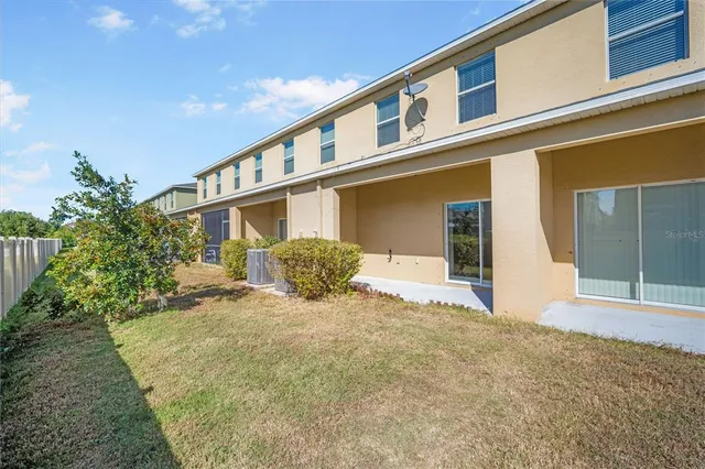 a tall white house with a large windows