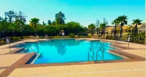 a view of a swimming pool with a lawn chairs