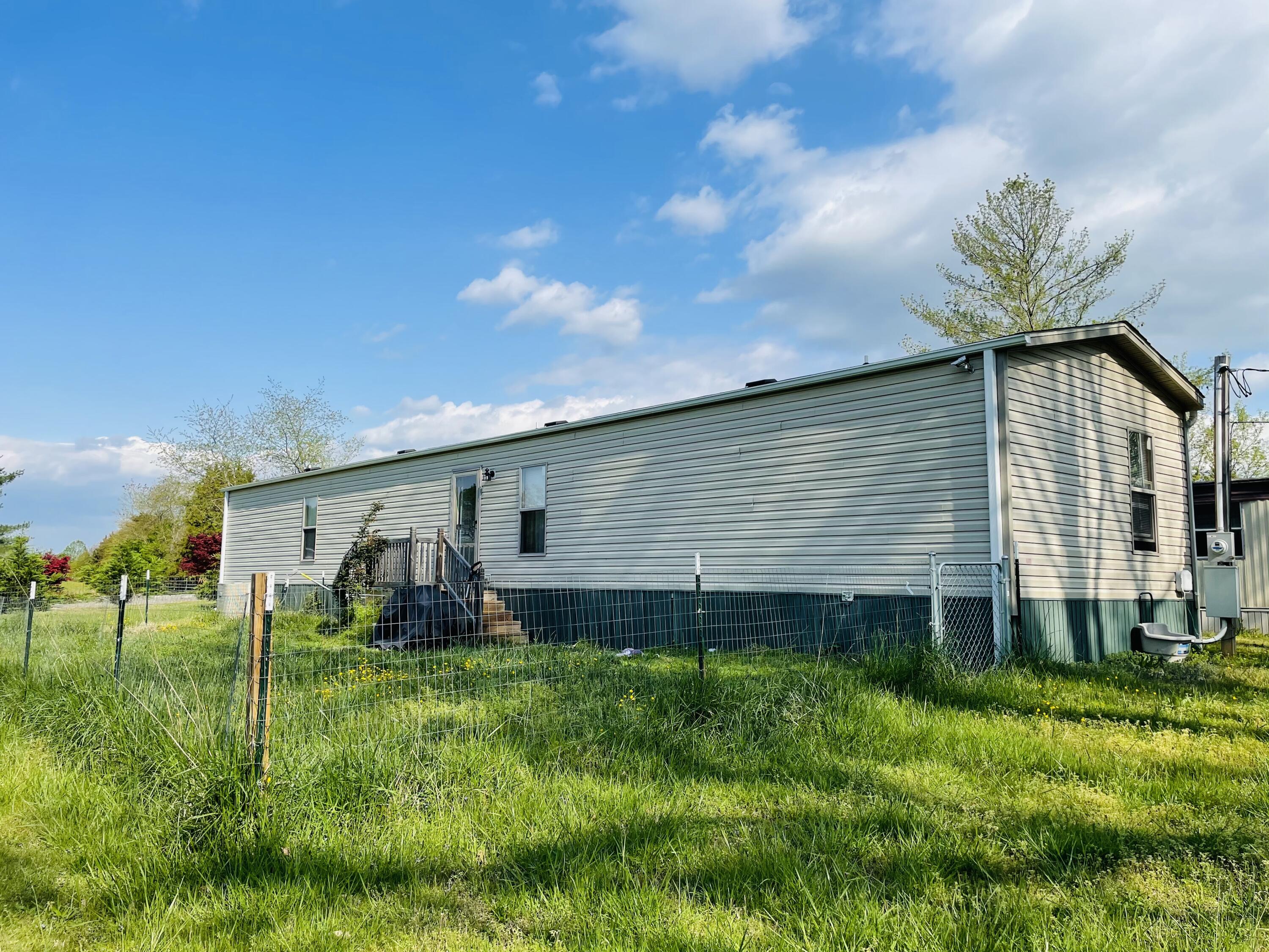 1344 Eagleview Road Goodview, VA 24095 - Photo 2 of 3 a backyard of a house with plants and garden