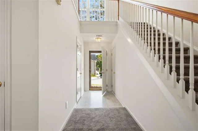 a view of a hallway with wooden floor and entryway