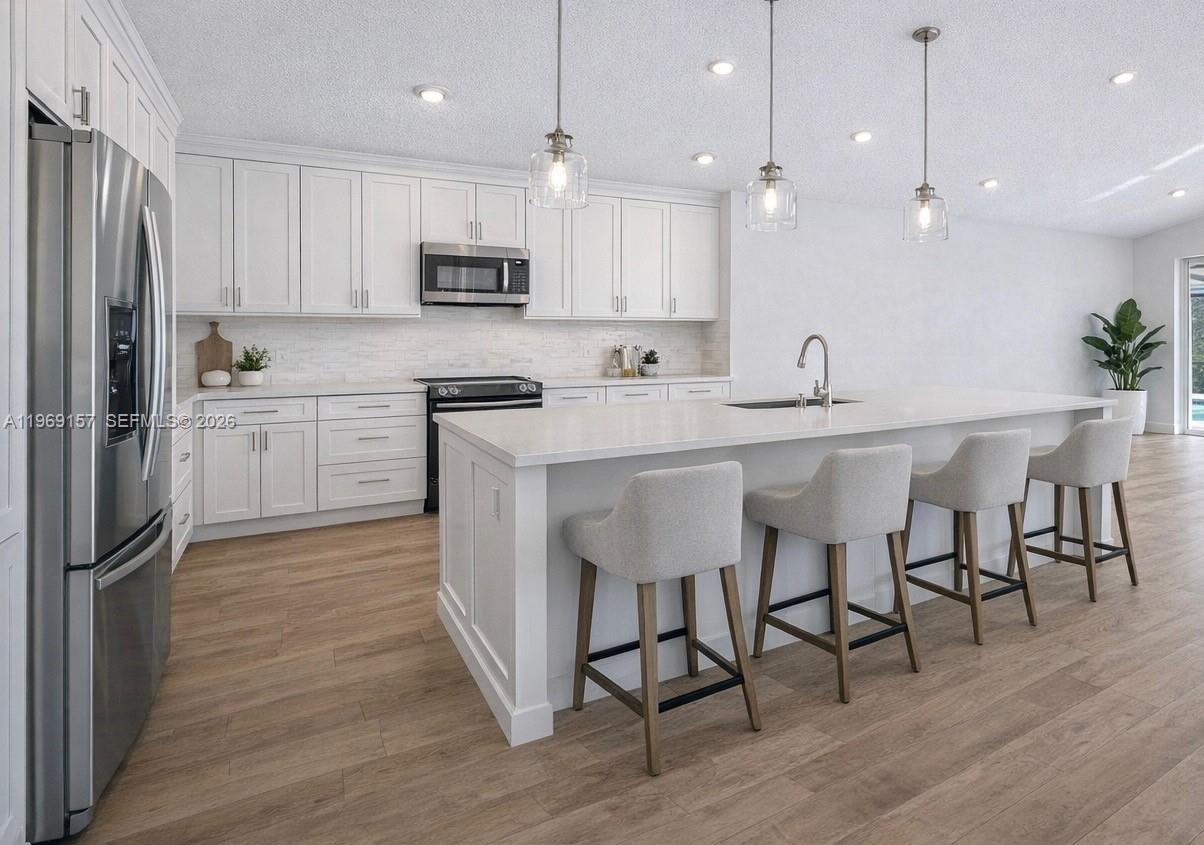3280 Huntington Weston, FL 33332 - Photo 21 of 64 DIGITALLY ENHANCED to show how the kitchen can look with an island, white walls and neutral flooring