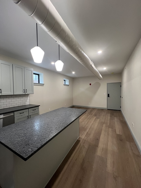 160 Seabury Street, Unit 1 Fall River, MA 02720 - Photo 13 of 13 a kitchen with a center island and wooden floor