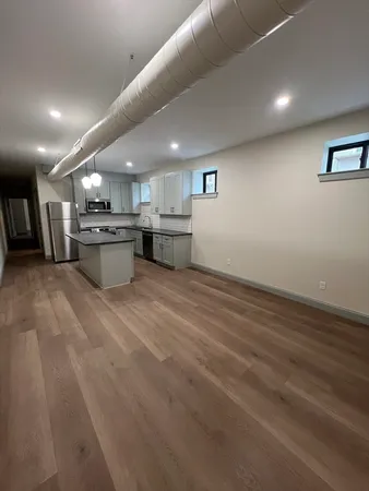 a large kitchen with stainless steel appliances a large counter top