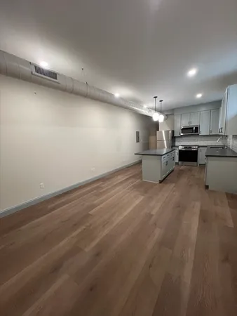 a view of a kitchen with a sink and cabinets