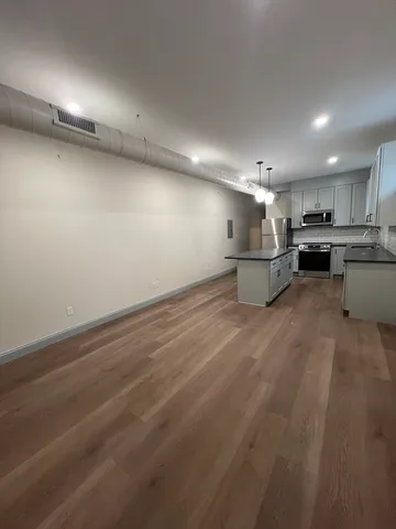 a view of a kitchen with a sink and cabinets