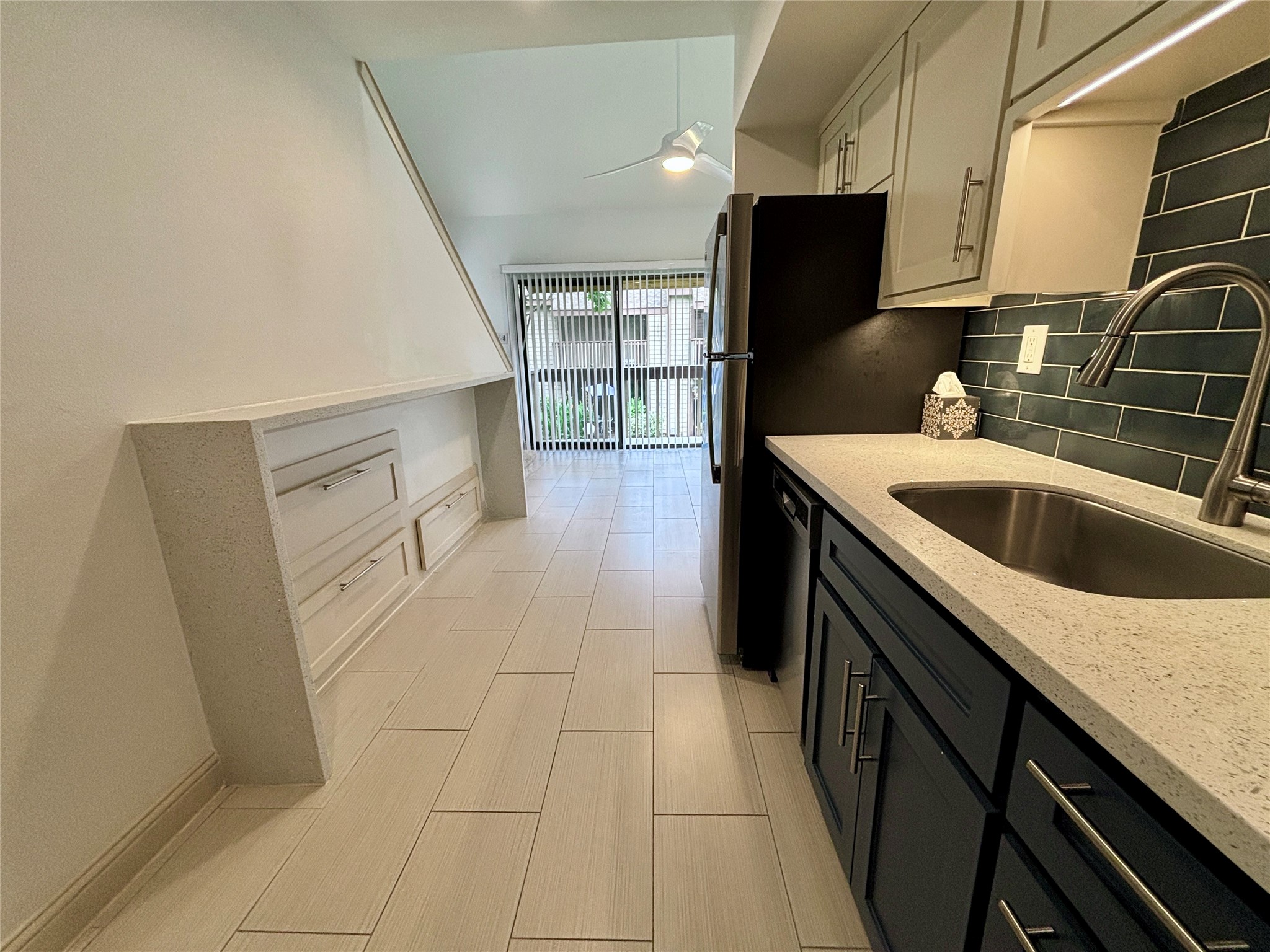 12900 Walden Road, Unit 508E Montgomery, TX 77356 - Photo 7 of 25 a kitchen with a sink and refrigerator
