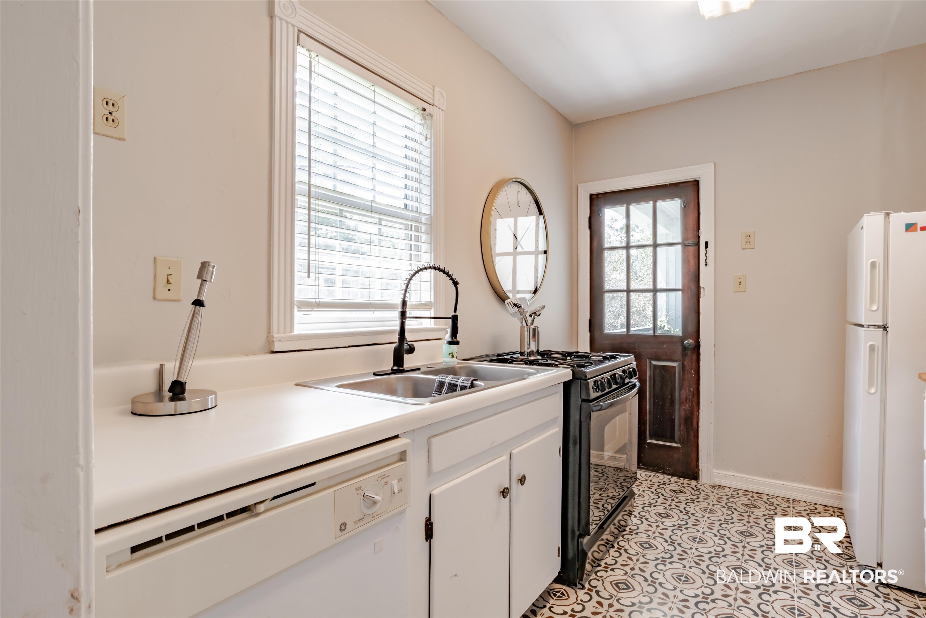 214 Upham Street, Unit 7C Mobile, AL 36607 - Photo 9 of 32 Kitchen with white appliances, white cabinetry, and light countertops