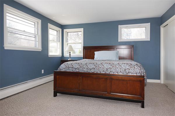 412 George Hill Road Lancaster, MA 01523 - Photo 12 of 26 a bed sitting in a bedroom next to a window