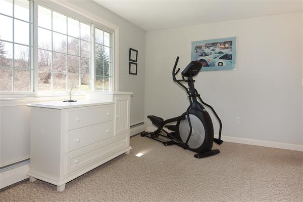 412 George Hill Road Lancaster, MA 01523 - Photo 16 of 26 a view of a room with gym equipment