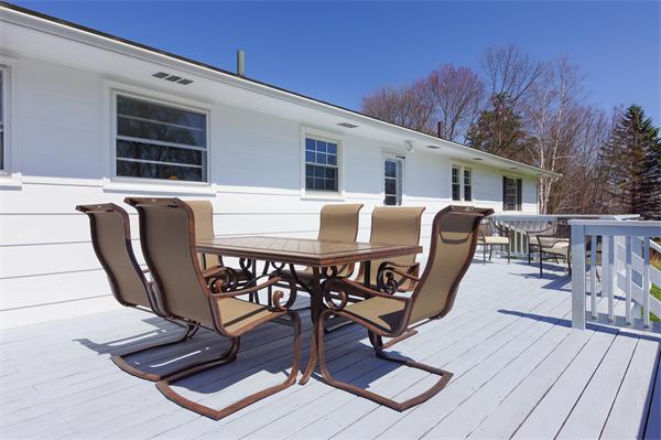412 George Hill Road Lancaster, MA 01523 - Photo 21 of 26 a view of a dinning table and chairs in patio of the house