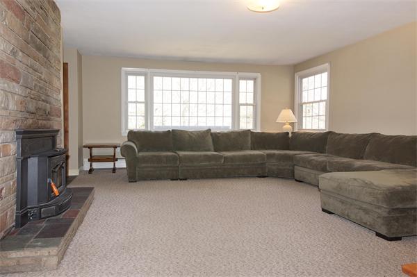 412 George Hill Road Lancaster, MA 01523 - Photo 4 of 26 a living room with furniture and a fireplace
