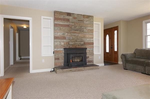 412 George Hill Road Lancaster, MA 01523 - Photo 5 of 26 a living room with furniture and a fireplace
