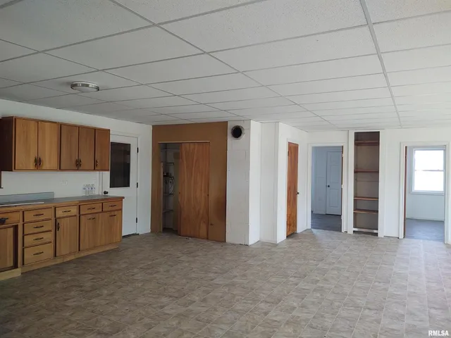 a large room with a sink and cabinets