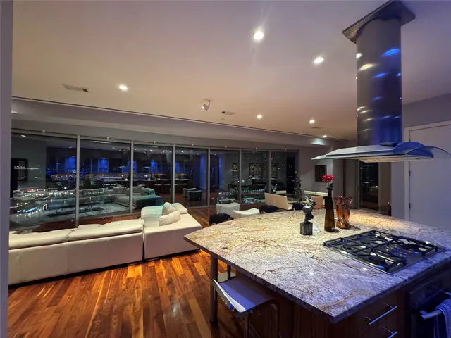 a kitchen with stainless steel appliances granite countertop a stove and a wooden cabinets