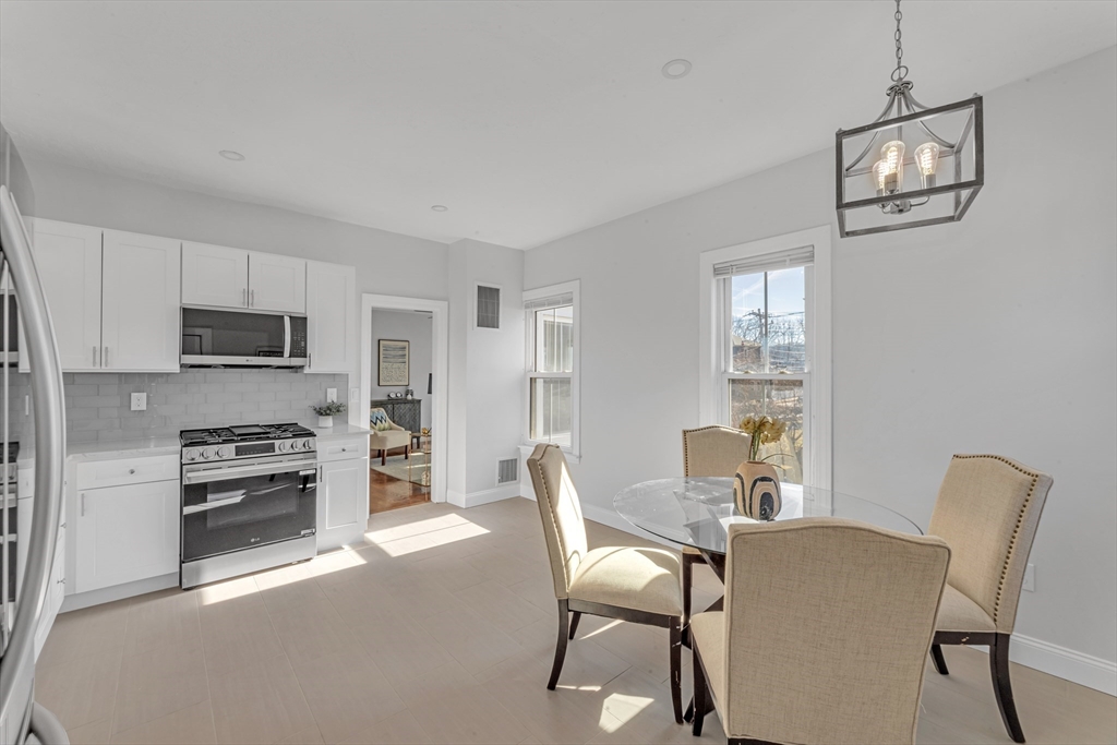 419 Poplar Street Boston, MA 02131 - Photo 2 of 27 a dining room with furniture and window