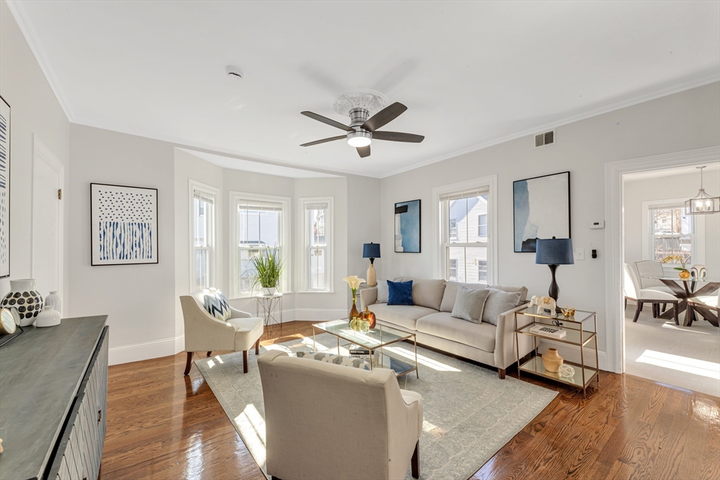 419 Poplar Street Boston, MA 02131 - Photo 6 of 27 a living room with furniture a large window and a chandelier