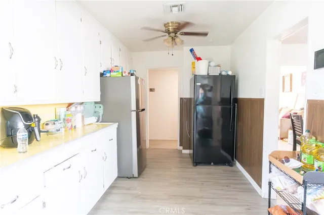 a kitchen with refrigerator and cabinets