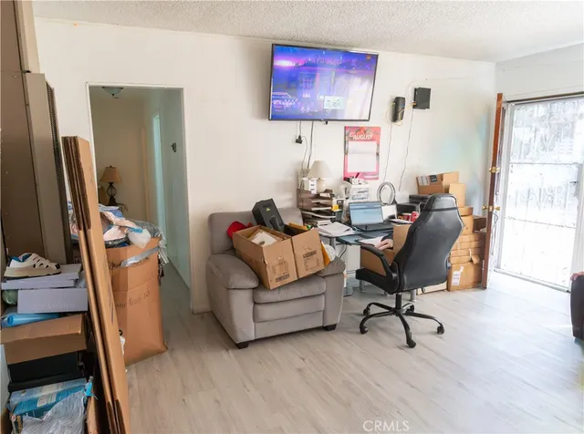 a bedroom with a bed and a computer on a desk